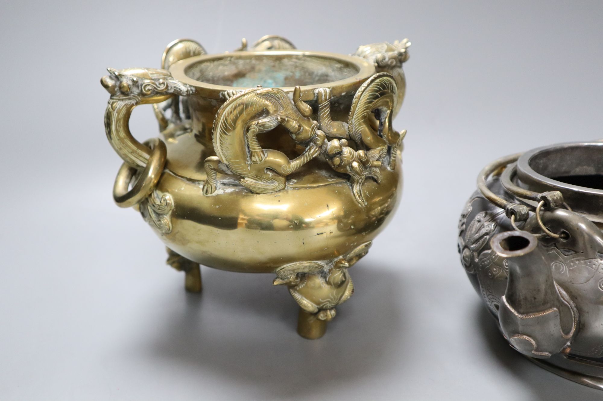 A Chinese bronze tripod censer, height 16cm, and a Chinese pewter-mounted Yixing pottery teapot, lacking lid (2)